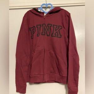 Pink. a burgundy zip up hoodie.